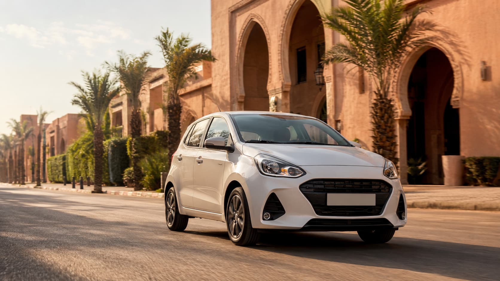 White compact car on a palm-lined street