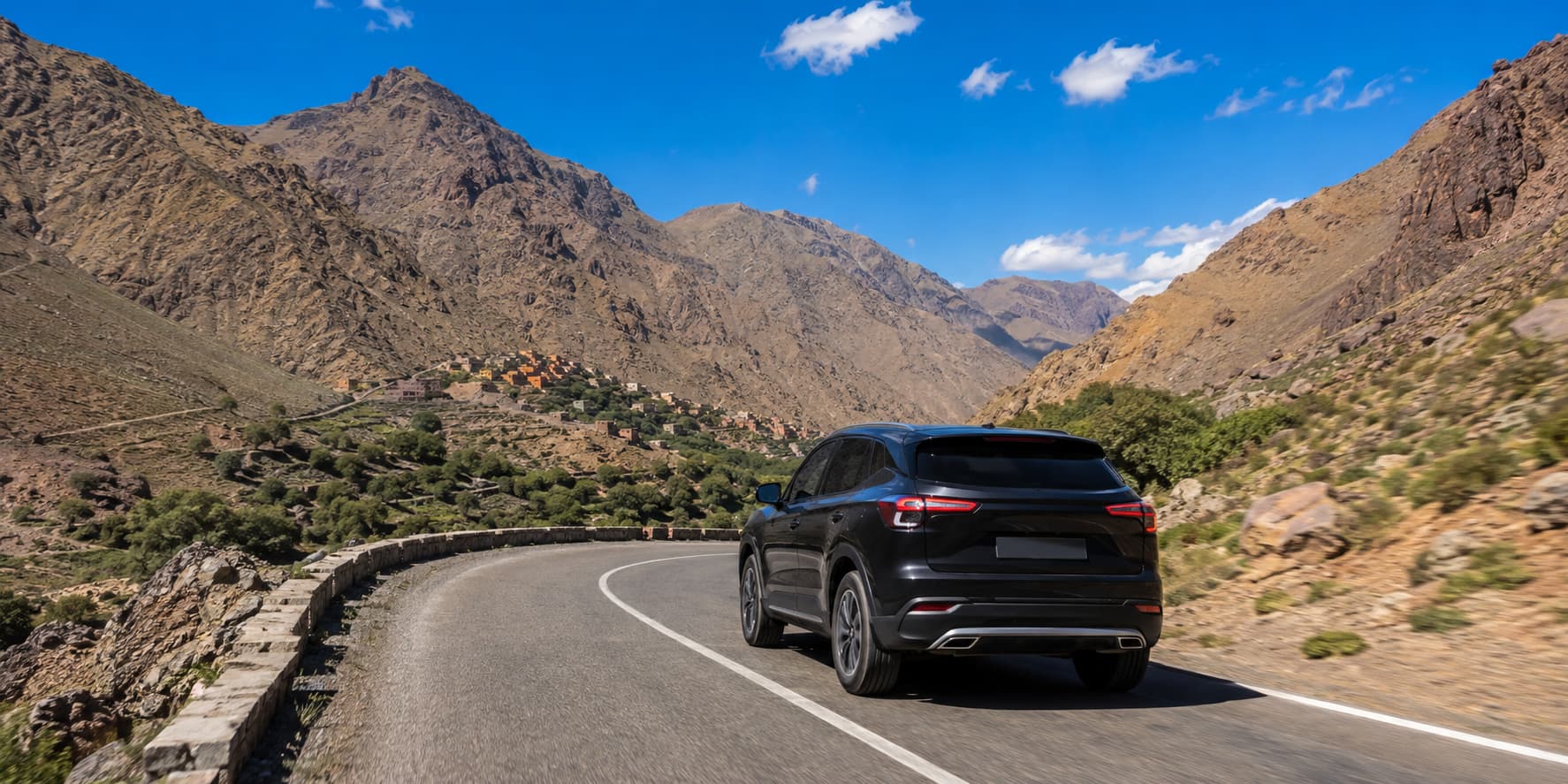 Black SUV on a winding mountain road